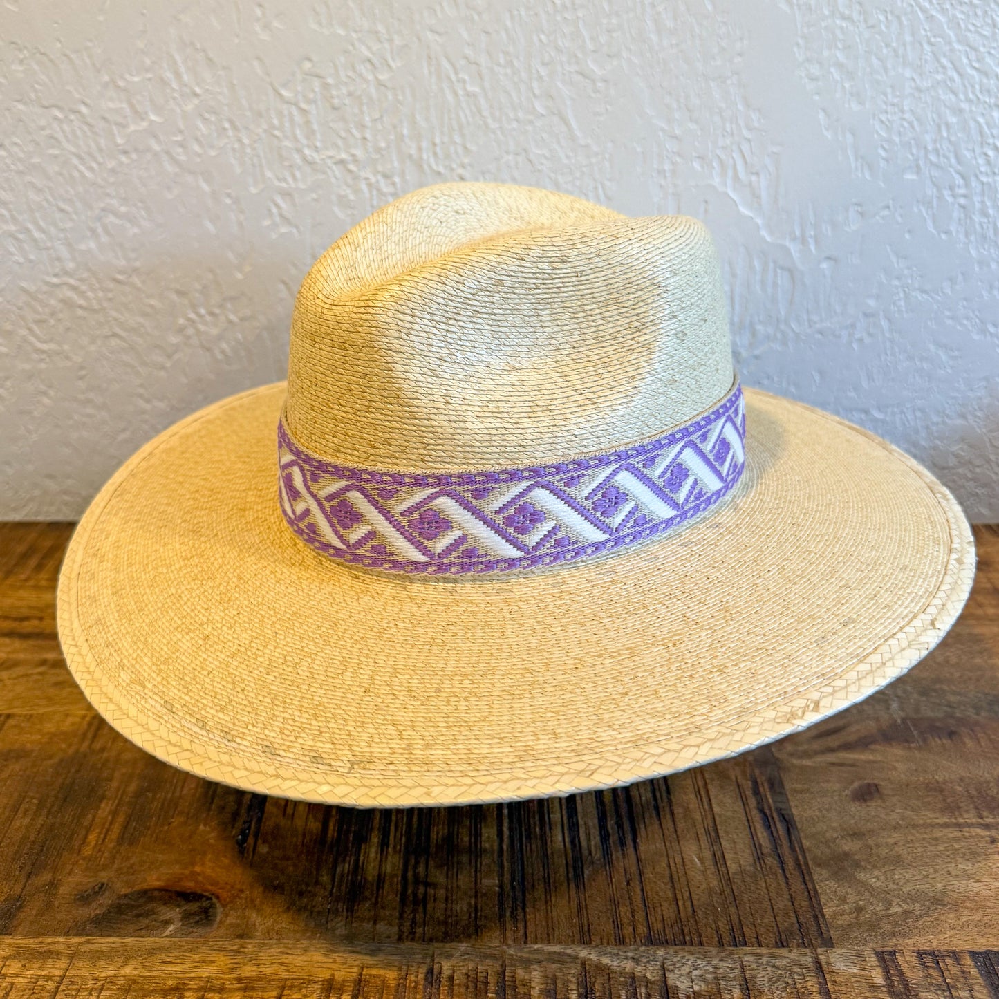Women's straw palm leaf hat with custom purple and white patterned band. 